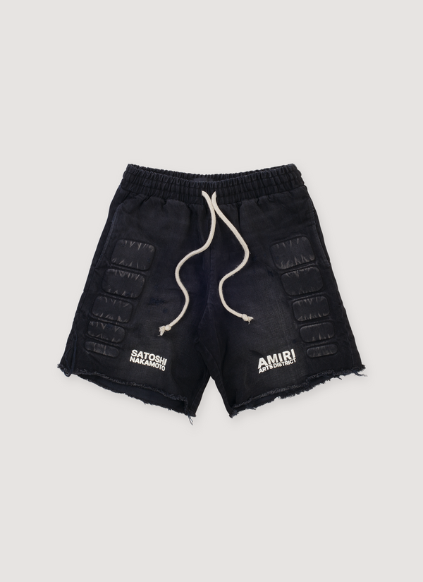 Amiri Satoshi Nakamoto Moto Cotton Denim Shorts Washed Black (Pre-Owned) with 3D moto pads, elasticated waist, puff printed logos, raw edge hem, front view Satoshi Nakamoto Moto Shorts Washed Black (Pre-Owned) - Authenticated Shorts | Pieces Los Angeles