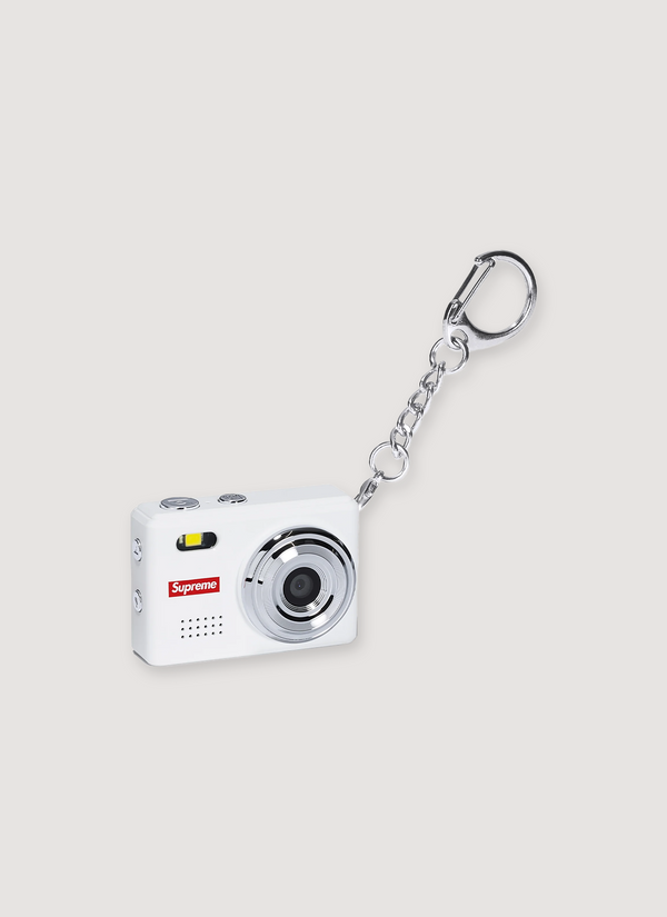 Supreme Digital Camera Keychain white ultra compact digital mini camera with printed SUpreme logo, 32 GB TF card, lanyard and clip keyrin, front view Digital Camera Keychain - Authenticated | Pieces Los Angeles
