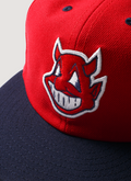 Pieces God vs Devil Baseball Cap Hat Red Navy with Devil logo, front close up view of front logo Pieces God vs Devil Baseball Cap Red Navy - Image 3 | Authenticated at Pieces Los Angeles