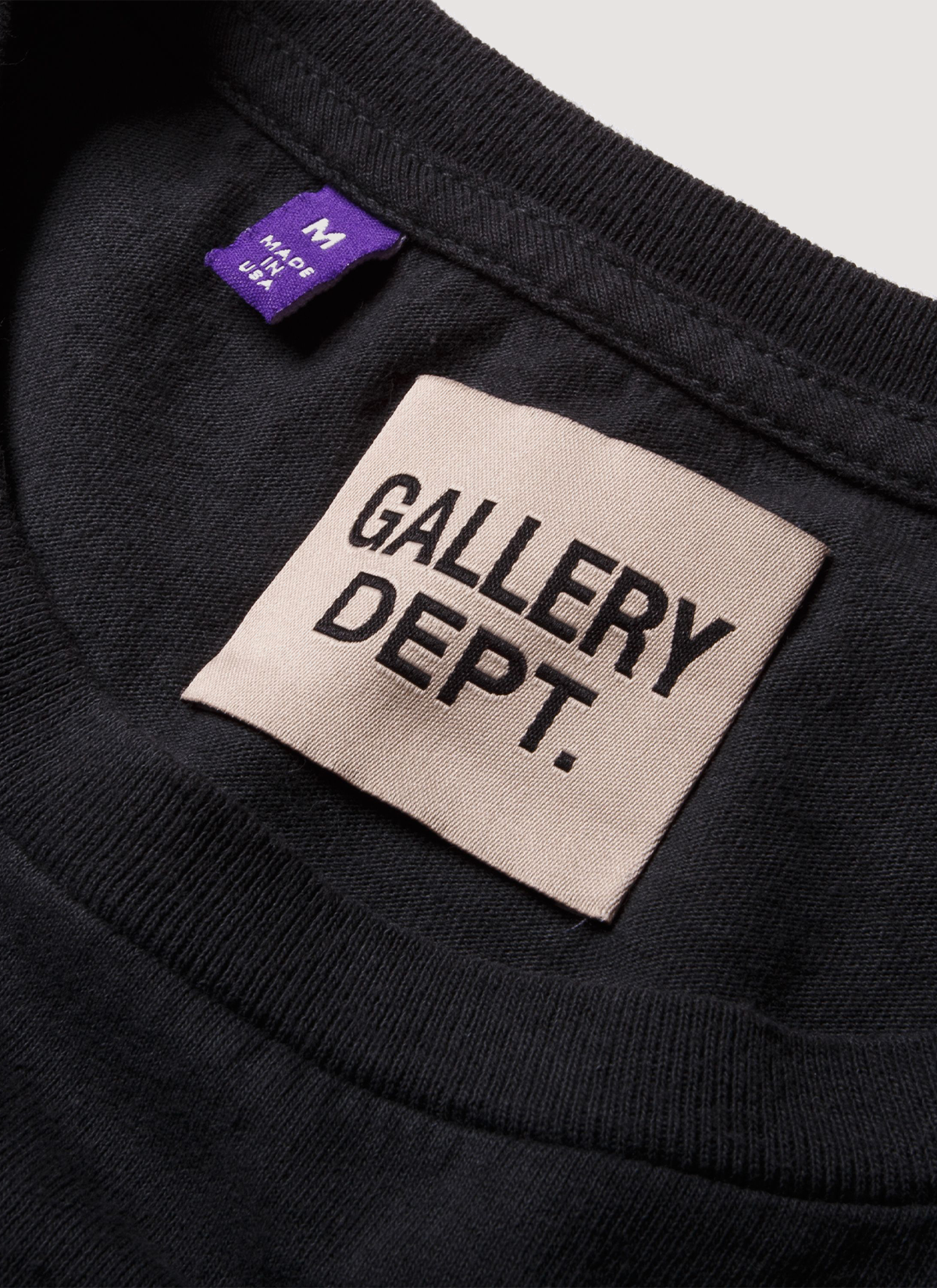 Gallery Dept Distressed ATK Tee Shirt Washed Black close up view of the neck tag Gallery Dept. Distressed ATK Tee Washed Black - Image 3 | Authenticated at Pieces Los Angeles
