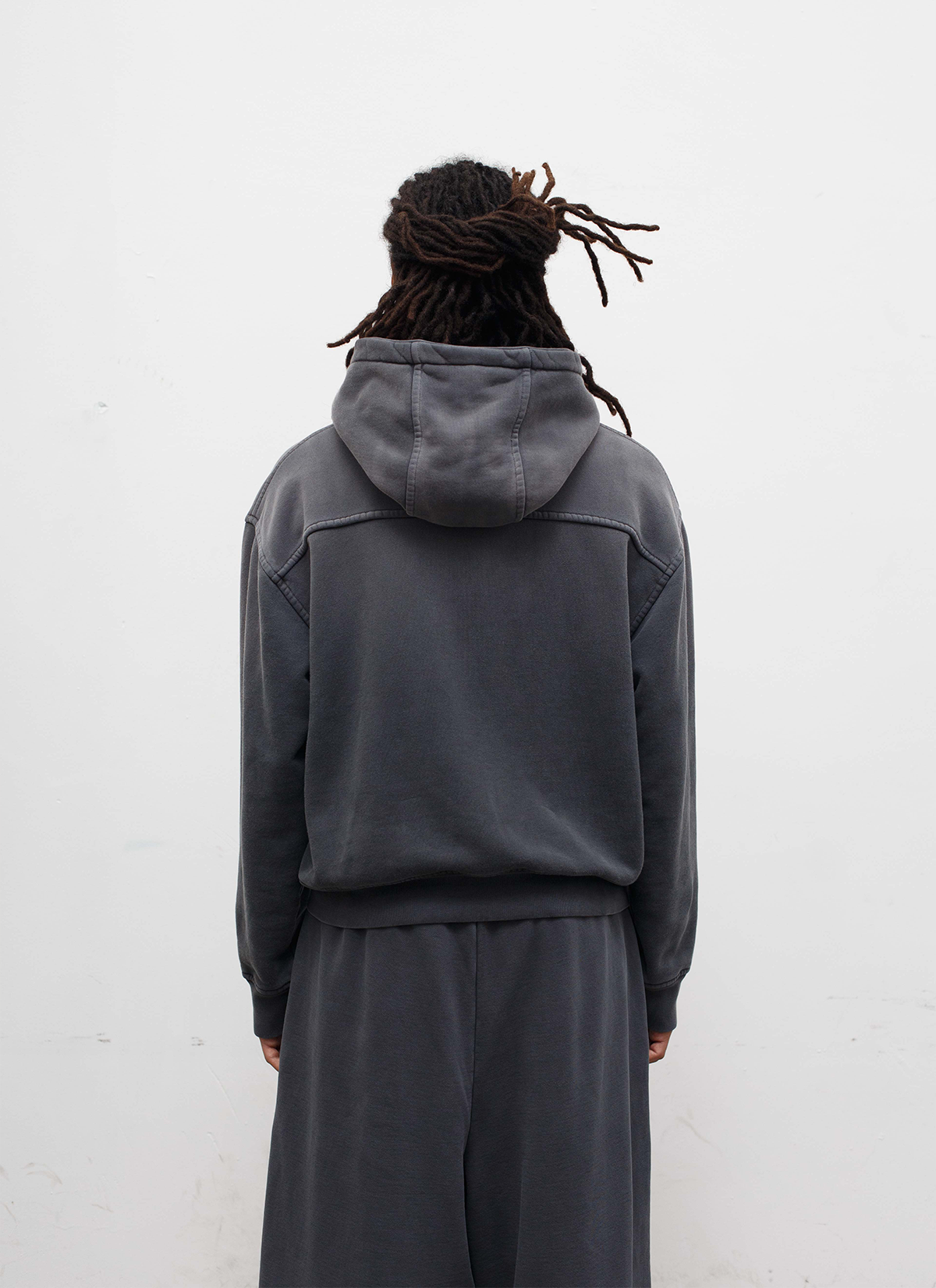 Picture of a man facing away, wearing the Pieces Basic Program Zip Up Sweatshirt Washed Black grey hoodie with zipper Pieces Basic Program Zip Up Sweatshirt Washed Black - Image 4 | Authenticated at Pieces Los Angeles