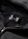 Close up of the tag on the Pieces Basic Program Zip Up Sweatshirt Washed Black grey hoodie with zipper partially opened Pieces Basic Program Zip Up Sweatshirt Washed Black - Image 5 | Authenticated at Pieces Los Angeles