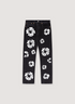 Denim Tears Cotton Wreath Denim Jeans Black with white wreath flower graphics all over, front view