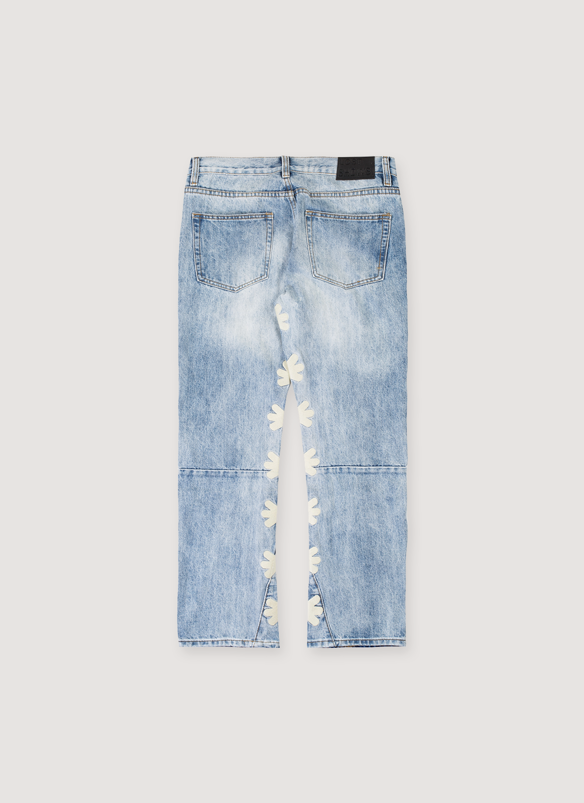 Los SHDWS Denim Blue Bone jeans with white asterisk logos running down the inside of both legs from the groin, back view