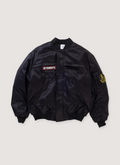 Vetements Police Bomber Black (Pre-Owned) Jacket with cotton and nylon, velcro attachable embroidered patch details, snap and zip front closure, zippered outer pockets, snap inner pockets, oversized, front view Vetements Police Bomber Black (Pre-Owned) - Image 1 | Authenticated at Pieces Los Angeles