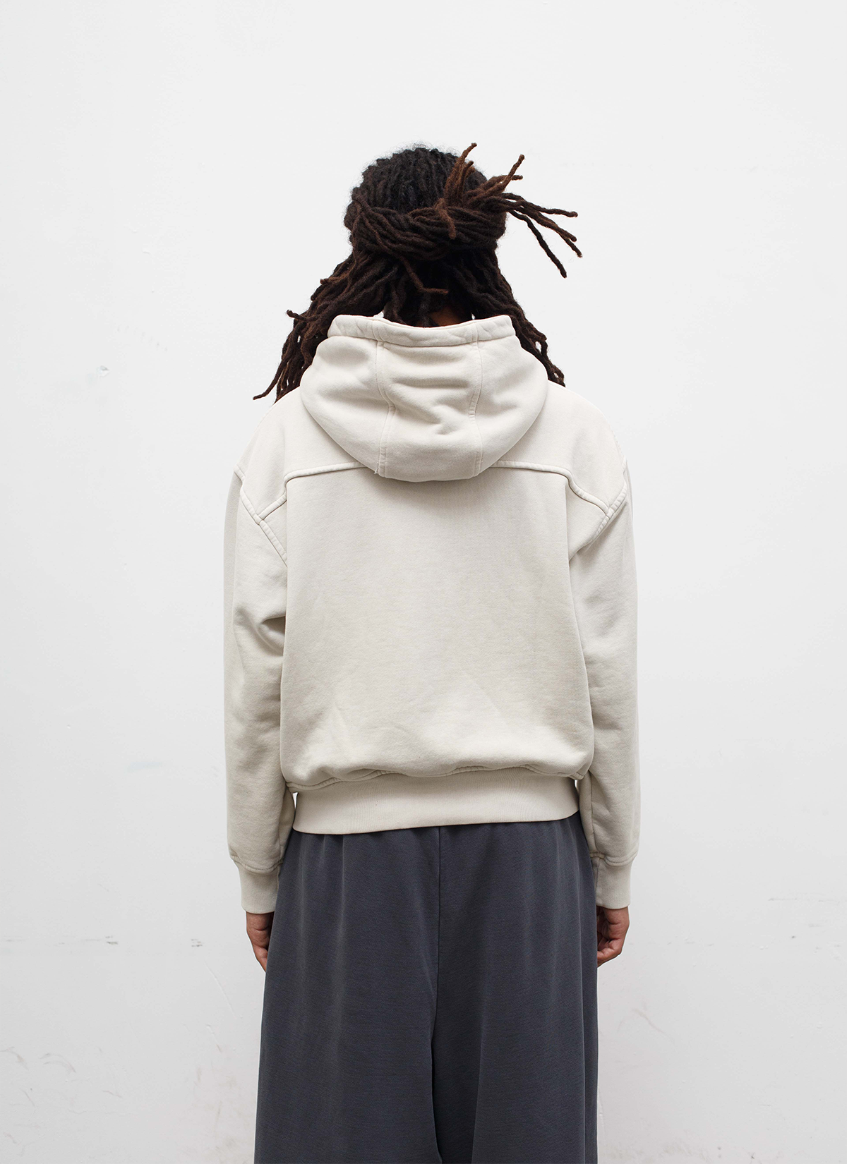 Man wearing sweatpants and the Pieces Basic Program Zip Up Sweatshirt Bone White Off-White back view Pieces Basic Program Zip Up Sweatshirt Bone - Image 4 | Authenticated at Pieces Los Angeles