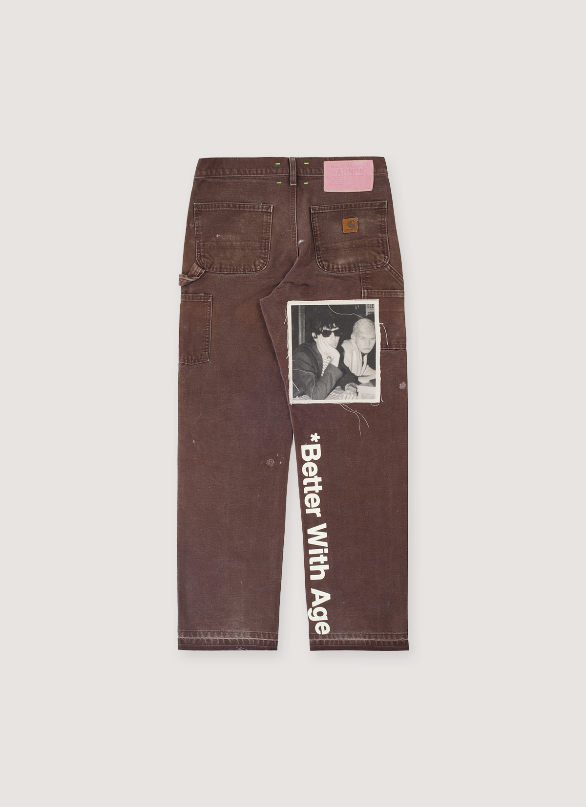 Better With Age Cambridge Carpenter Pants Brown double knee trousers, opened bottom hem, puff print logos and printed sewn on patch and white text, custom leather back tab, back view Better With Age Cambridge Carpenter Pants Brown - Image 2 | Authenticated at Pieces Los Angeles