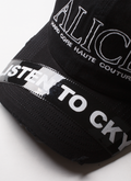 Alice Hollywood Listen to CKY Cap Black Hat with white embroidered logos, lighter cap details, and printed sticked patch on the brim, close up top view Alice Hollywood Listen to CKY Cap Black - Image 5 | Authenticated at Pieces Los Angeles