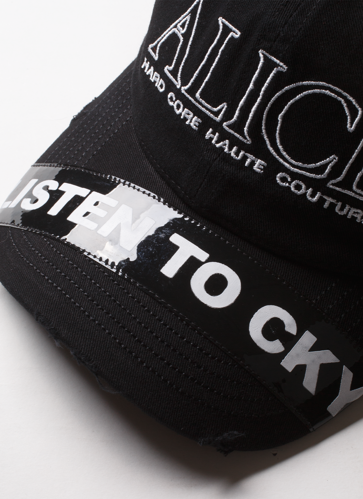 Alice Hollywood Listen to CKY Cap Black Hat with white embroidered logos, lighter cap details, and printed sticked patch on the brim, close up top view Alice Hollywood Listen to CKY Cap Black - Image 5 | Authenticated at Pieces Los Angeles