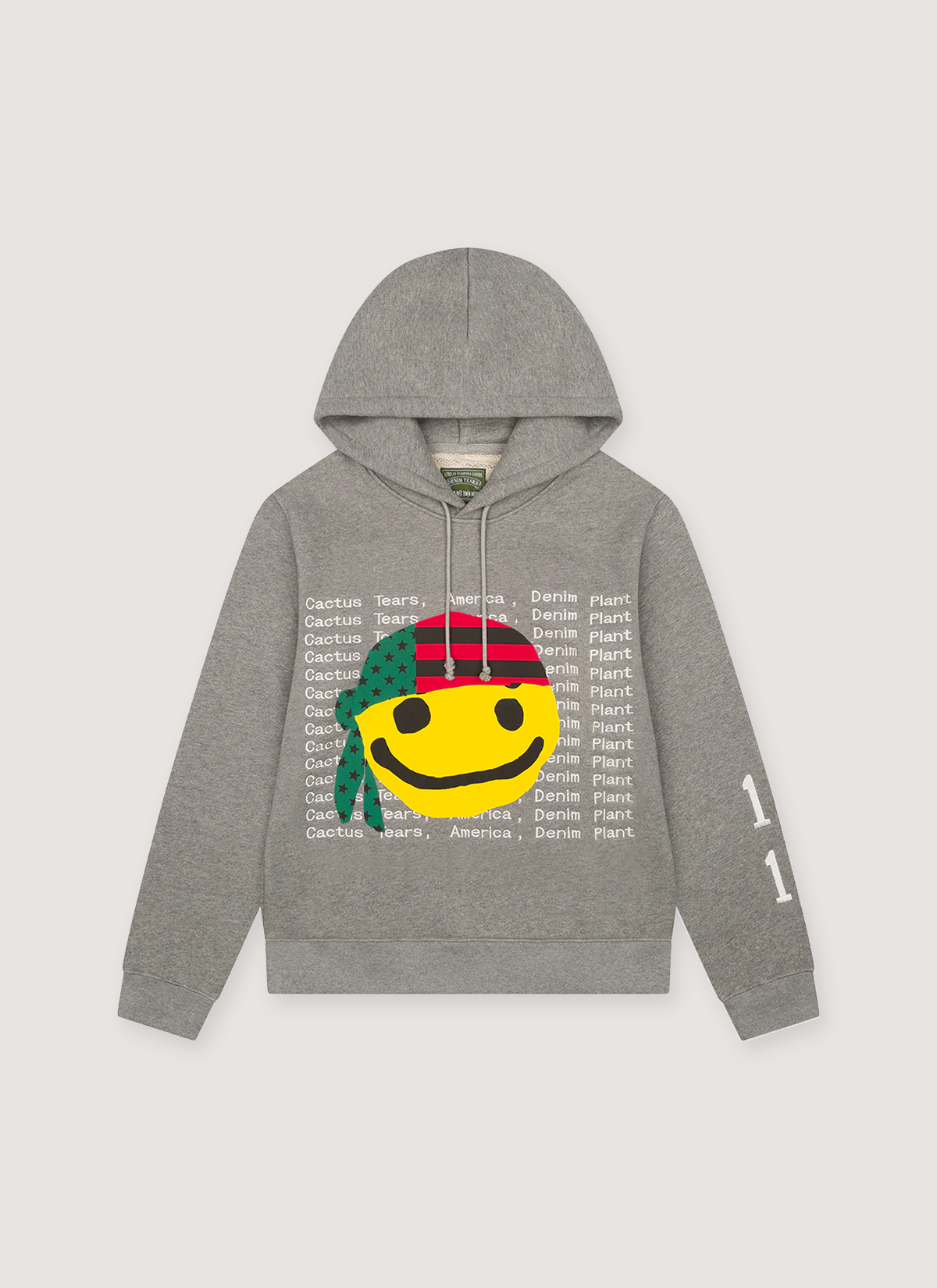 Denim Tears CPFM Cactus Tears Sweatshirt Grey hoodie with white text all over and a graphic of a yellow happy face with a green and red bandana, front view