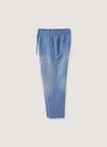 Happy Memories Don't Die HMDD Crystal faded Sweatpants Powder Blue Sweatpants with rhinestones, side profile view HMDD Crystal Sweatpants Powder Blue - Image 2 | Authenticated at Pieces Los Angeles