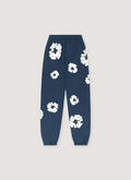 Denim Tears Cotton Wreath Sweatpants Navy, cuffed with white wreaths flowers all over, front view Denim Tears Cotton Wreath Sweatpants Navy - Image 1 | Authenticated at Pieces Los Angeles
