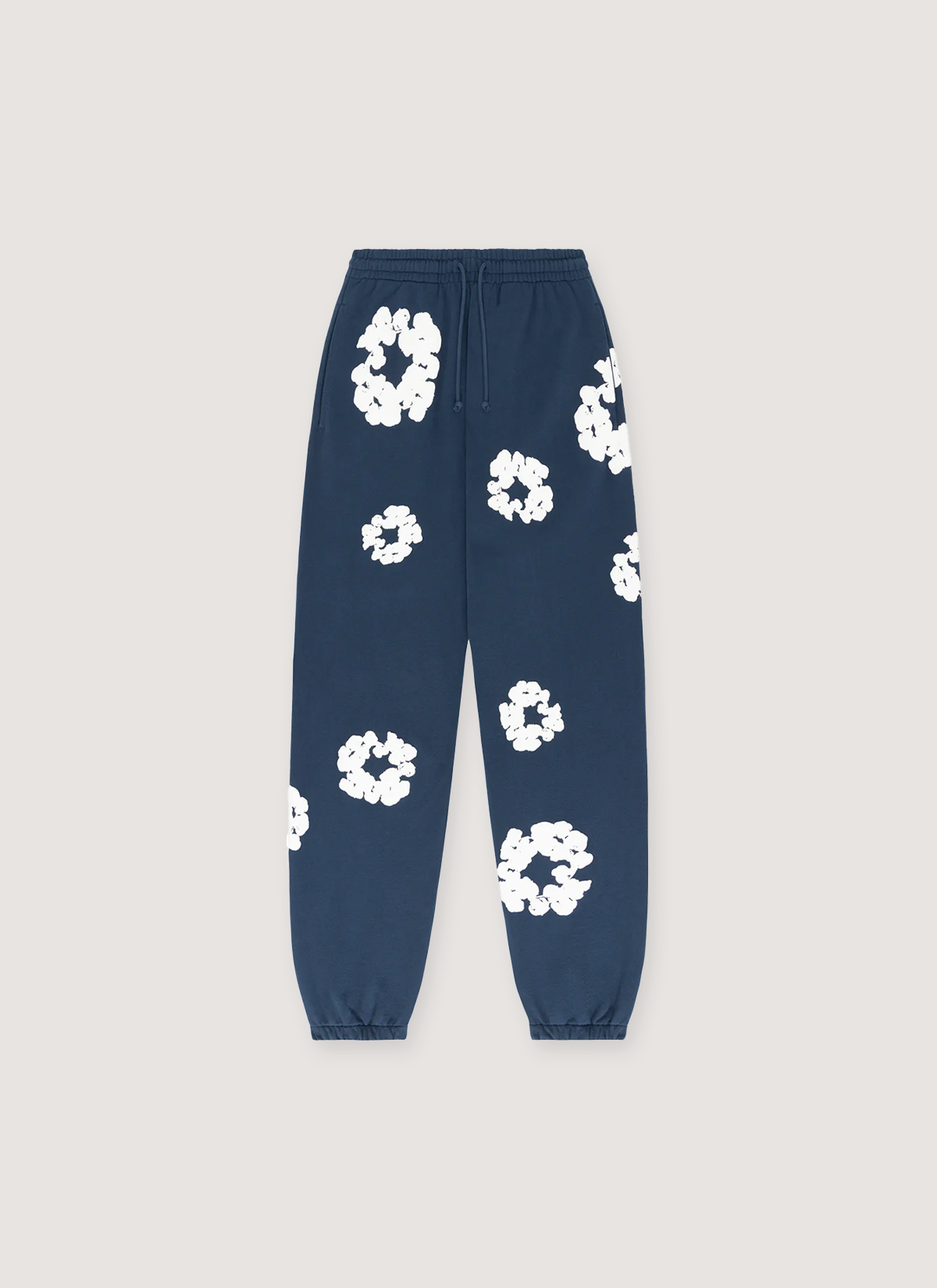 Denim Tears Cotton Wreath Sweatpants Navy, cuffed with white wreaths flowers all over, front view