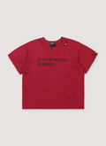 Enfants Riches Déprimés Classic Logo Tee Shirt Damaged Red with rib knit neckline, printed black text logo, distressed details, paint splatters, signature wash process, single stitch hems, front view Enfants Riches Déprimés Classic Logo Tee Damaged Red - Image 1 | Authenticated at Pieces Los Angeles