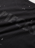 Pieces F***ed vintage black tee shirt with paint splatter and vintage text close up view of back Pieces F***ed Tee Vintage Black - Image 4 | Authenticated at Pieces Los Angeles