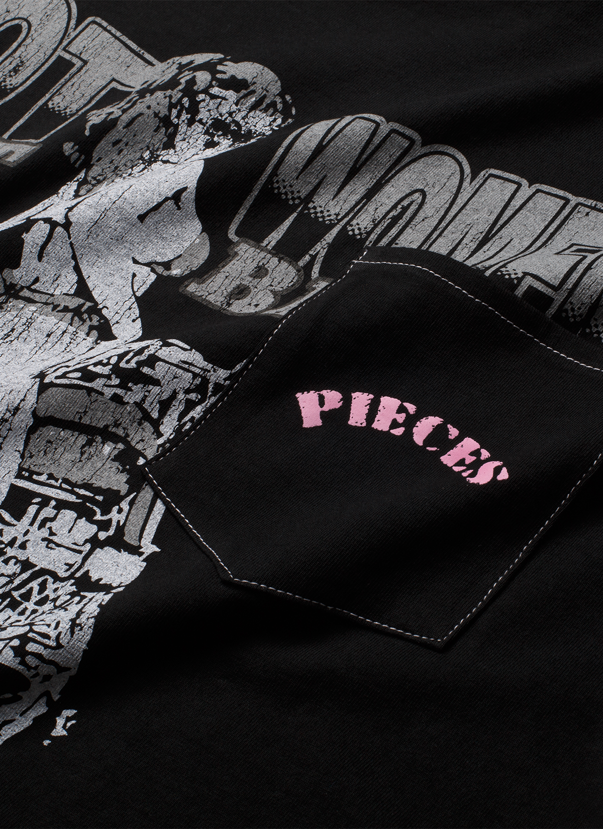 Pieces Fast Bikes Pocket Tee Shirt Vintage Black with graphic of woman riding a motorcycle, with a front pocket with pink text on it, close up view