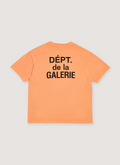 Gallery Dept. French Logo Tee Shirt Flo Orange with printed black logo text that says Dept de la Galerie, vintage wash and dye methods, boxy, flowy fit, back view Gallery Dept. French Logo Tee Flo Orange - Image 2 | Authenticated at Pieces Los Angeles