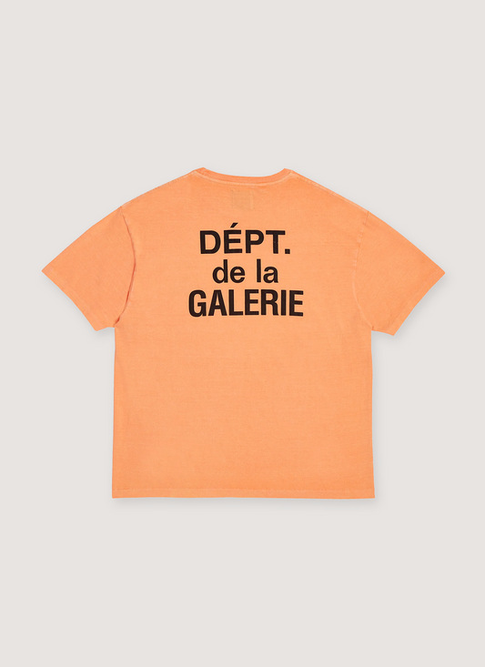 Gallery Dept. French Logo Tee Shirt Flo Orange with printed black logo text that says Dept de la Galerie, vintage wash and dye methods, boxy, flowy fit, back view