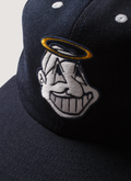 Pieces God Vs Devil Baseball Cap hat Navy Blue with a graphic of a Native American Indian head with a halo, close up of graphic Pieces God Vs Devil Baseball Cap Navy - Image 3 | Authenticated at Pieces Los Angeles