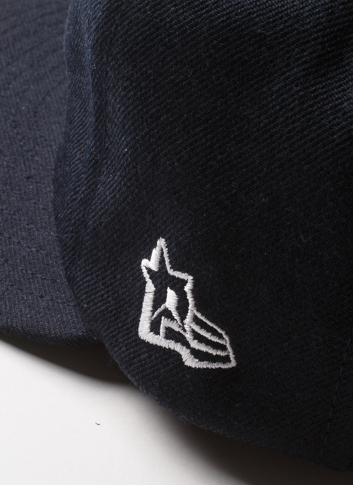 Pieces God Vs Devil Baseball Cap hat Navy Blue close up view of logo stitched on side Pieces God Vs Devil Baseball Cap Navy - Image 4 | Authenticated at Pieces Los Angeles