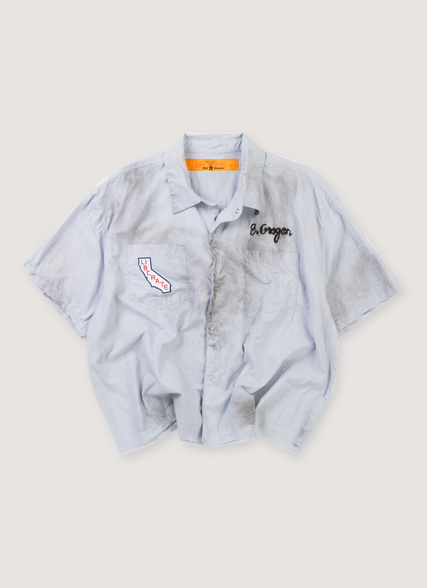 Paly Hollywood House of Richard Mechanic Shirt Baby Blue (Pre-Owned) garment dye utility work shirt with collar, single needle embroidery, chain stitched art, hand stained,distressed, raw edge hem, small logo patches, front view House of Richard Mechanic Shirt Baby Blue (Pre-Owned) - Authenticated Shirts | Pieces Los Angeles