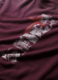Close up of the back graphic on the Pieces Inhumane Half Zip Sweatshirt Vintage Maroon hoodie with half-zip zipper Pieces Inhumane Half Zip Sweatshirt Vintage Maroon - Image 3 | Authenticated at Pieces Los Angeles
