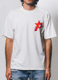 man wearing the Pieces P Star Flame Tee shirt Off White Scarlet with a red logo facing the camera Pieces P Star Flame Tee Off White Scarlet - Image 5 | Authenticated at Pieces Los Angeles
