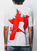 man wearing the Pieces P Star Flame Tee shirt Off White Scarlet with a big red logo facing away from the camera Pieces P Star Flame Tee Off White Scarlet - Image 4 | Authenticated at Pieces Los Angeles