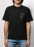 On-body shot of man wearing Pieces P Star Flame Tee shirt Tonal Black V2 front view Pieces P Star Flame Tee Tonal Black V2 - Image 3 | Authenticated at Pieces Los Angeles