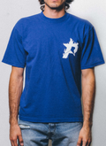 man wearing the Pieces P Star Flame Tee shirt Dodger Blue with a star logo facing the camera Pieces P Star Flame Tee Dodger Blue - Image 5 | Authenticated at Pieces Los Angeles