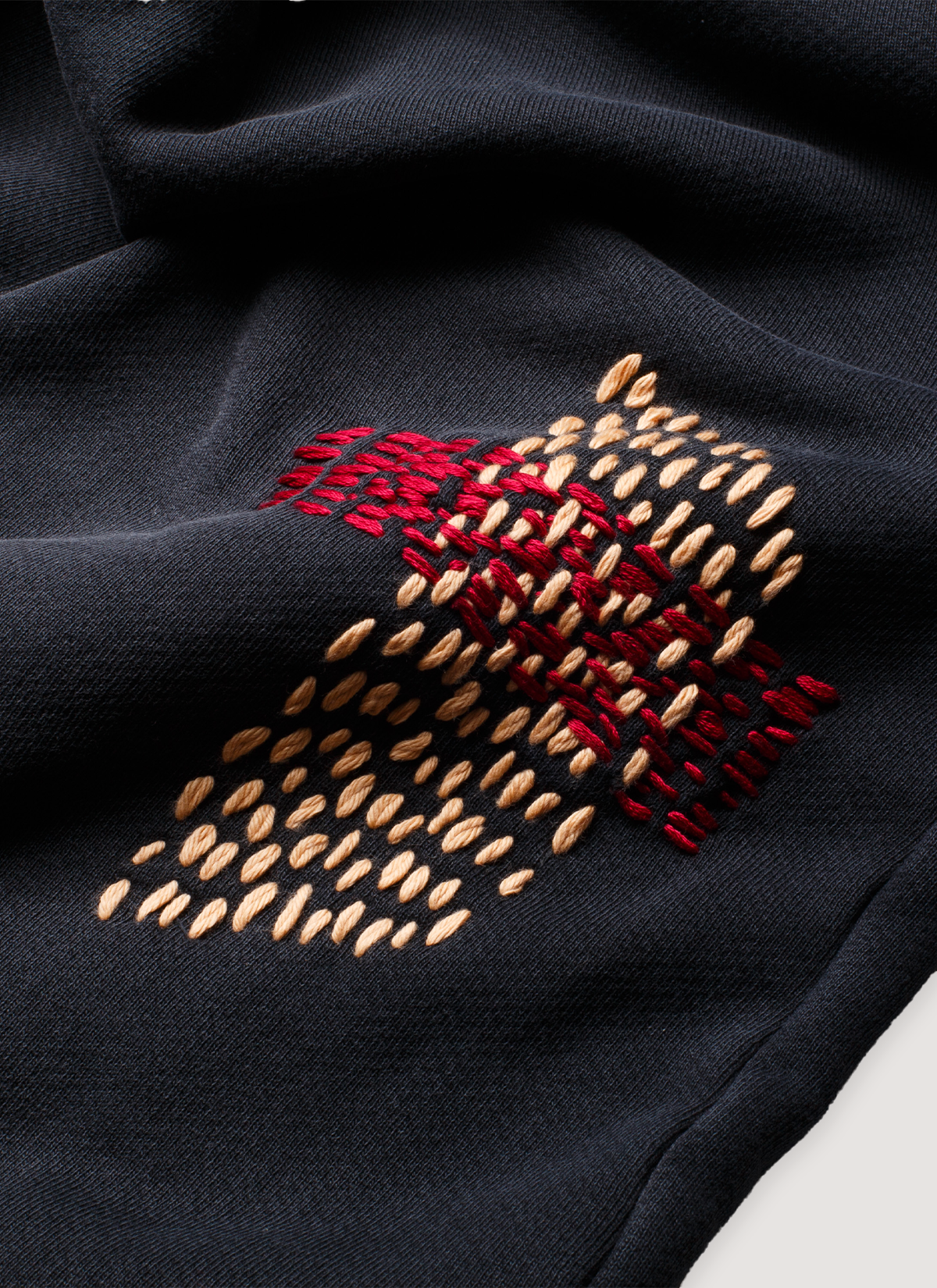Pieces Repair Pleated Sweatpants Vintage Black with Japanese style repair stitch work, close up view of orange and red stitchwork patchwork 