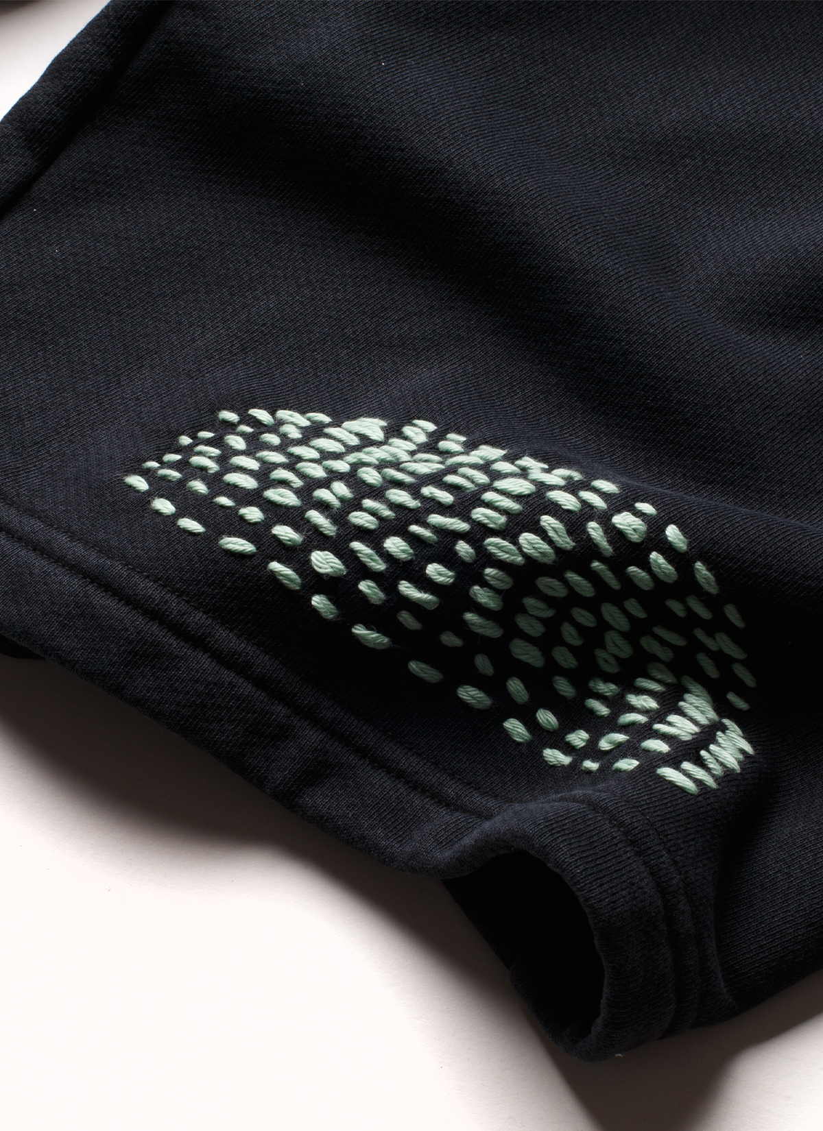 Pieces Repair Pleated Sweatpants Vintage Black with Japanese style repair stitch work, close up view of patchwork 