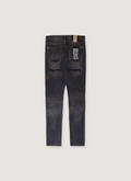Ksubi Van Winkle Retorqued Repair Denim Charcoal Black with back pockets and a patch on one of the pockets, tears and repairs below the pockets, back view Ksubi Van Winkle Retorqued Repair Denim Charcoal - Image 2 | Authenticated at Pieces Los Angeles