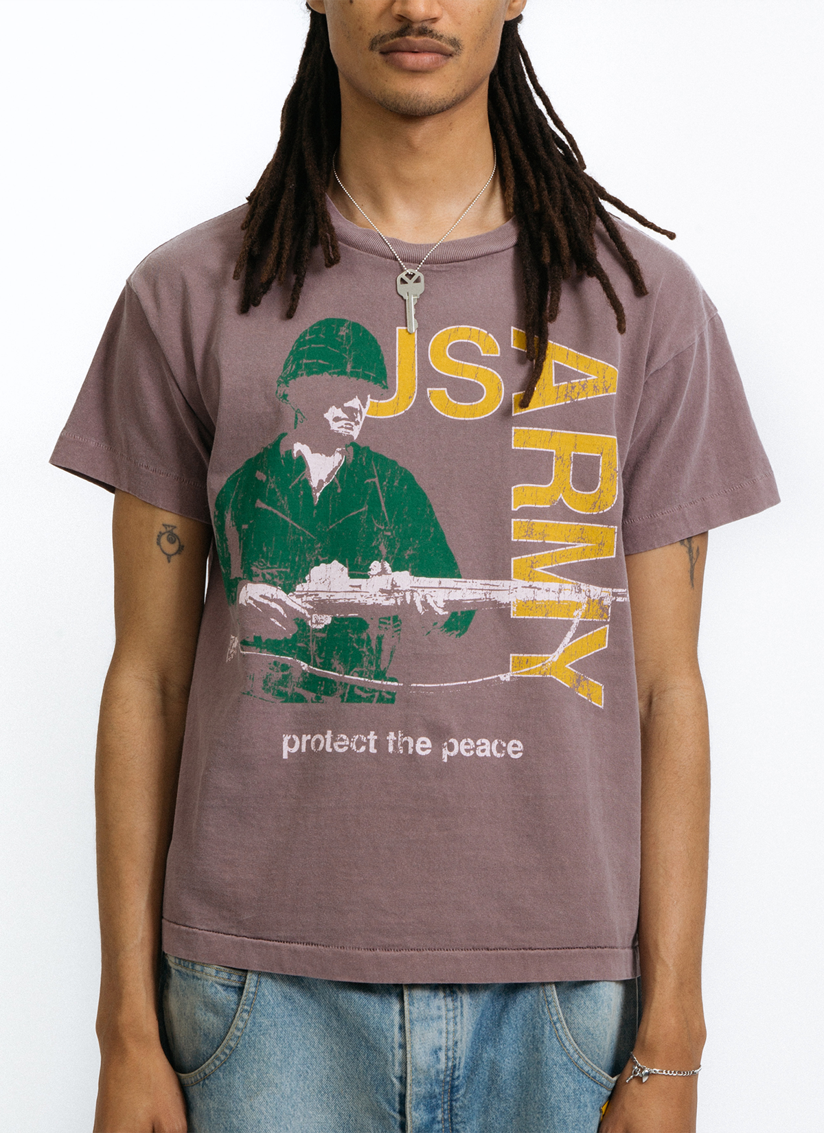 Man wearing the Pieces Rose Garden Tee Shirt Vintage Brown Stone with graphic of green soldier with yellow text, front view