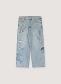 Boredom Kills Scribble Denim Jeans Indigo Blue with diestressings, tears, and and text all over, front view Boredom Kills Scribble Denim Indigo - Image 1 | Authenticated at Pieces Los Angeles