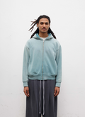 Man wearing sweatpants and the Pieces Basic Program Zip Up Sweatshirt Seafoam Green Blue front view, white background Pieces Basic Program Zip Up Sweatshirt Seafoam - Image 3 | Authenticated at Pieces Los Angeles
