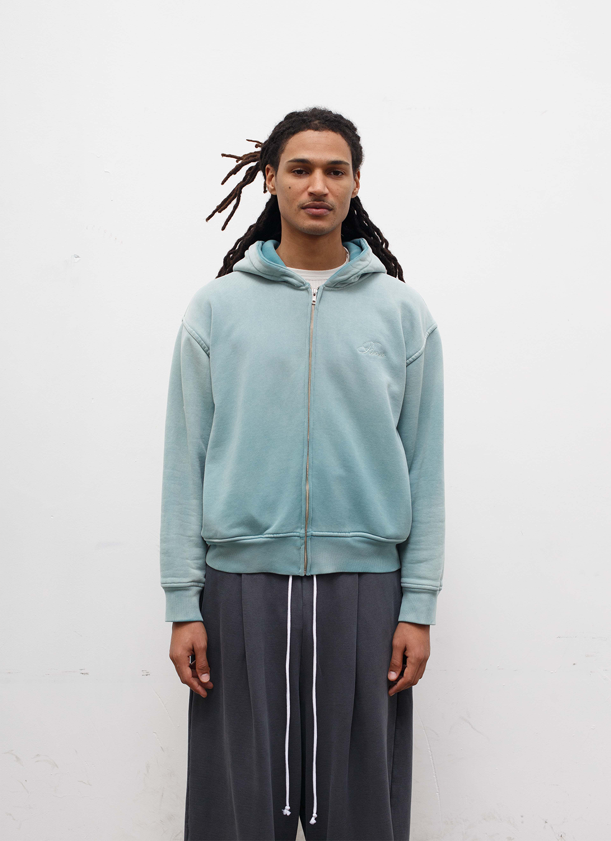 Man wearing sweatpants and the Pieces Basic Program Zip Up Sweatshirt Seafoam Green Blue front view, white background Pieces Basic Program Zip Up Sweatshirt Seafoam - Image 3 | Authenticated at Pieces Los Angeles