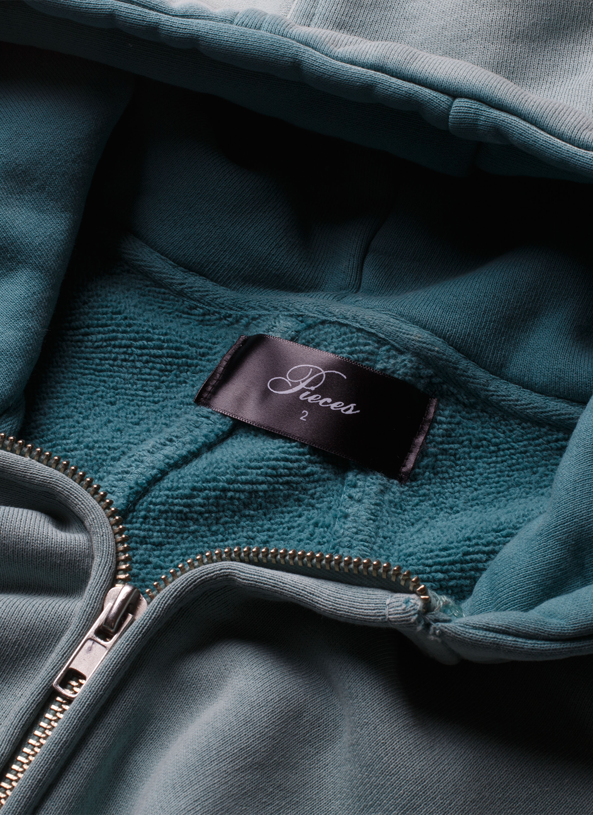 Pieces Basic Program Zip Up Sweatshirt Seafoam Green Blue, close up view of neck tag and zipper Pieces Basic Program Zip Up Sweatshirt Seafoam - Image 5 | Authenticated at Pieces Los Angeles