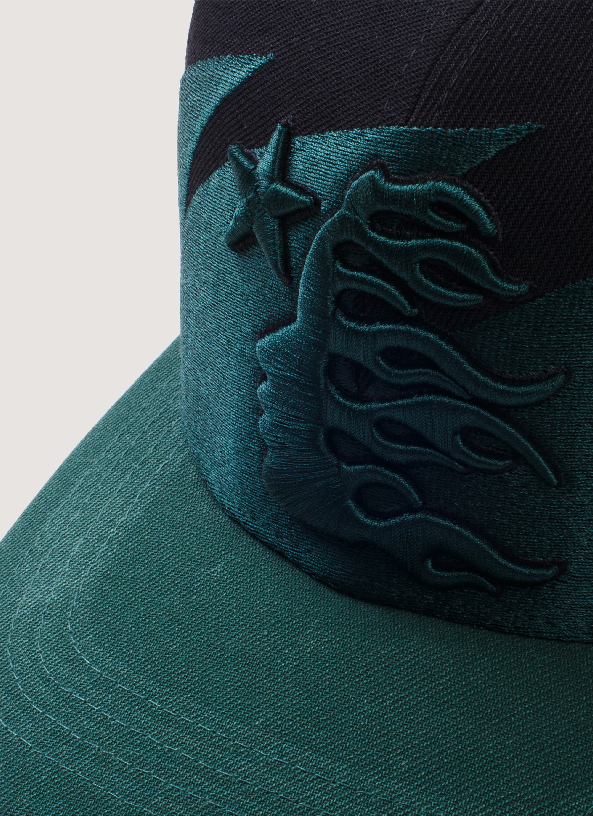 Hellstar Sharktooth Snapback Hat Black Green with embroidered sharktooth pattern, embroidered logos, rhinestone studded underbrim, adjustable back snap closure, close up view of front logo and brim Hellstar Sharktooth Snapback Hat Black Green - Image 3 | Authenticated at Pieces Los Angeles