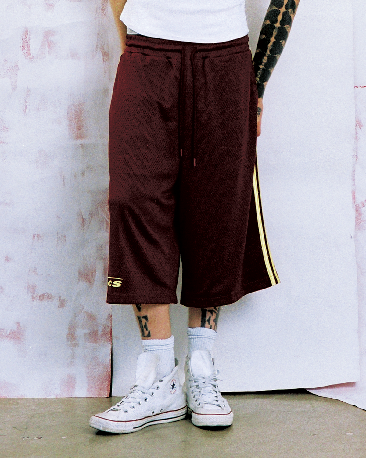 Model wearing New Age maroon shorts — Pieces Los Angeles