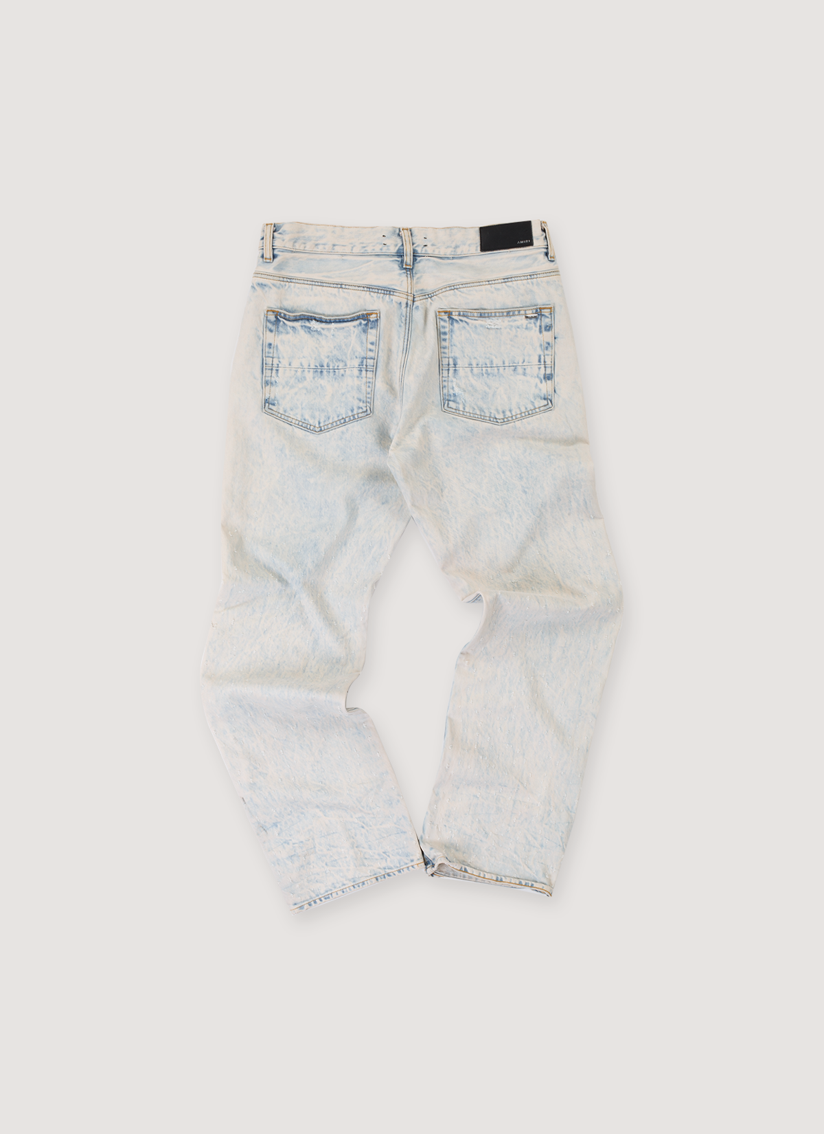 Amiri Shotgun Denim Jeans Acid Wash Cream Tan (Pre-Owned) with reguar rise, straight leg cut, leather logo back tab,, shotgun distressing, two pockets, back view