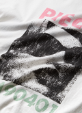 Pieces 90401 Tee Vintage White close up of front logo with faded image of woman wearing sunglasses Pieces 90401 Tee Vintage White - Image 3 | Authenticated at Pieces Los Angeles