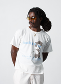 Man wearing Pieces Sounds Tee Shirt White with black and white graphic of a woman wearing traditional japanese kyoto and blue text, front view Pieces Sounds Tee White - Image 3 | Authenticated at Pieces Los Angeles