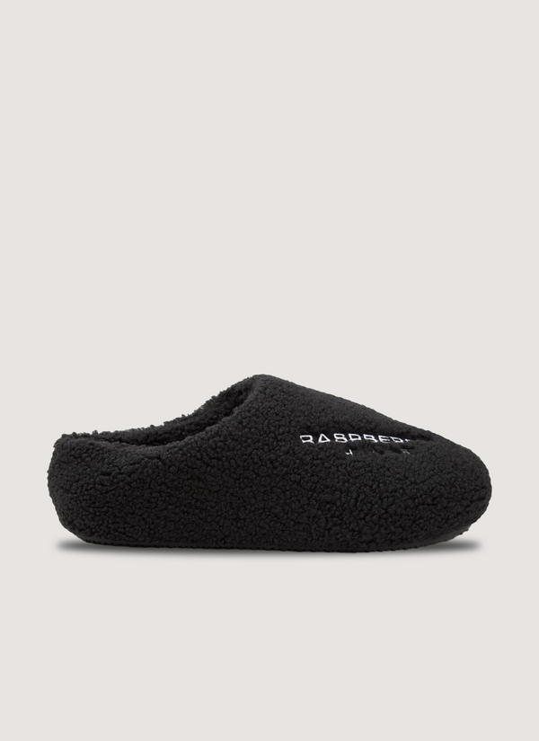 GV Gallery Stacy From The Woods Slips Black slip on slides, plush wool upper, rubber traction sole, embroidered logos, side profile Stacy From The Woods Slips Black - Authenticated Slides | Pieces Los Angeles
