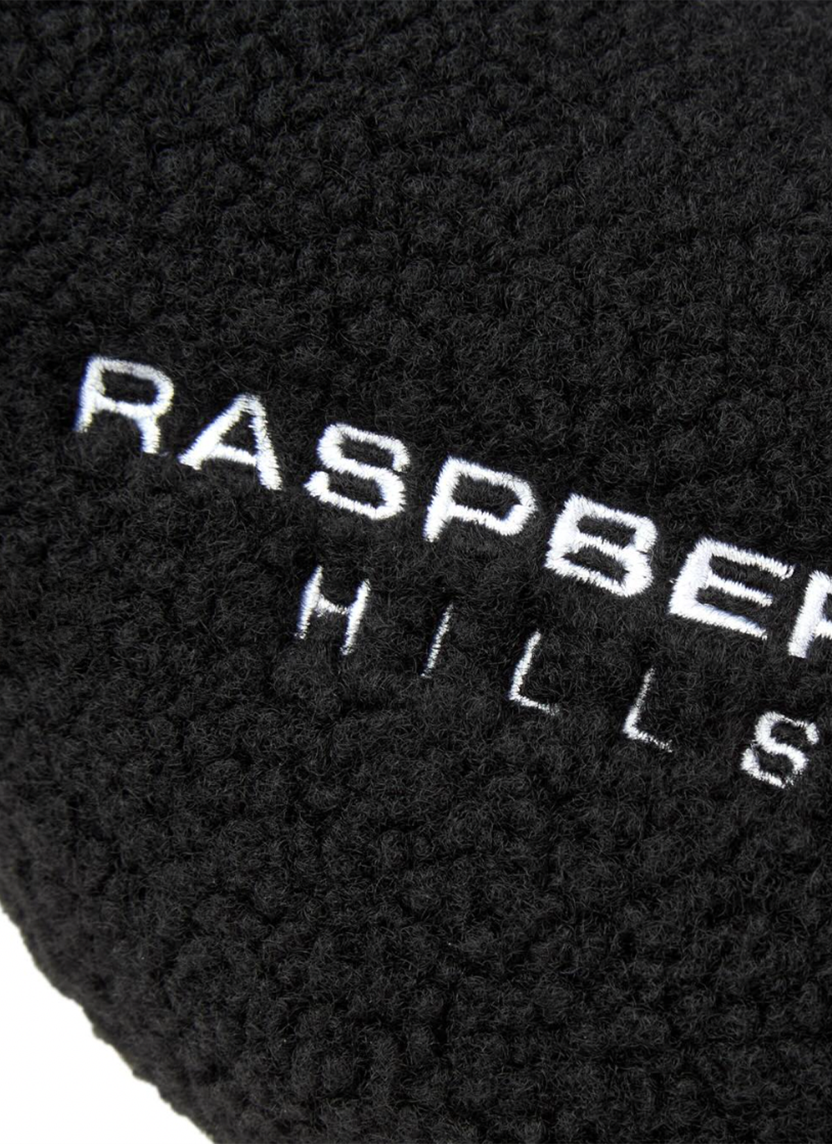 GV Gallery Stacy From The Woods Slips Black slip on slides, plush wool upper, rubber traction sole, embroidered logos, close up view of embroidered logo that says Raspberry Hills GV Gallery Stacy From The Woods Slips Black - Image 2 | Authenticated at Pieces Los Angeles