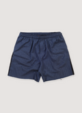 Gallery Dept. Zuma Shorts Pinstripe Navy (Pre-Owned) with side and back pockets, dead-stock military fabric, subtle pinstripe print, raw edge hem, above the knee fit, front view Gallery Dept. Zuma Shorts Pinstripe Navy (Pre-Owned) - Image 1 | Authenticated at Pieces Los Angeles