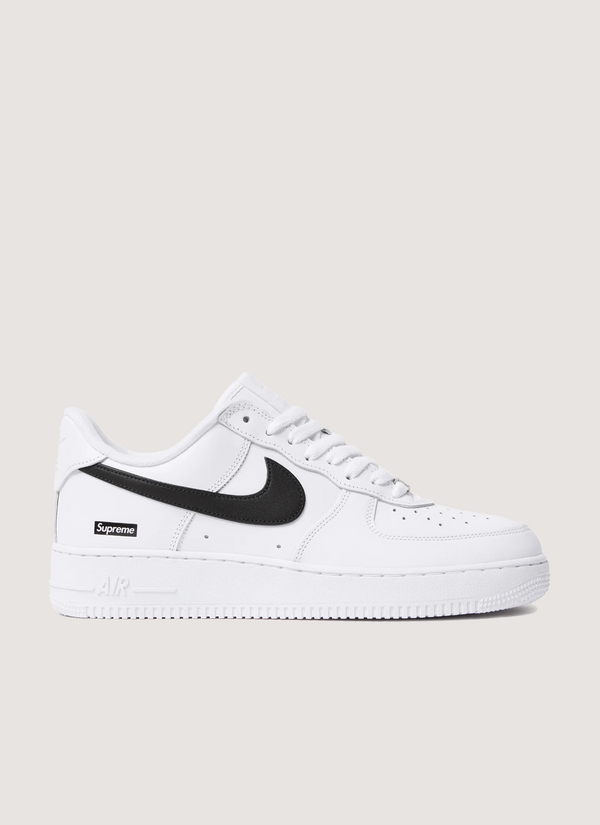 Nike Supreme Air Force 1 White (2025) with black swoosh, full grain leather upper, perforated leather toe panel, DURAPLUSH lining, co-branded footbed, debossed printed logo, Supreme branded laces, side profile view Supreme Air Force 1 White (2025) - Authenticated Sneakers | Pieces Los Angeles