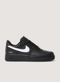 Nike Supreme Air Force 1 Black (2025) with white swoosh, full grain leather upper, perforated leather toe panel, DURAPLUSH lining, co-branded footbed, debossed printed logo, Supreme branded laces, side profile view Supreme Air Force 1 Black (2025) - Image 1 | Authenticated at Pieces Los Angeles