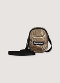 Supreme Denim Mini Utility Bag Realtree Camo with water resistant Cordura nylon, embossed logo lining, additional zip, interior pocket, adjustable shoulder strap, embossed 3M logo, woven logo Supreme Denim Mini Utility Bag - Image 1 | Authenticated at Pieces Los Angeles