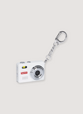 Supreme Digital Camera Keychain white ultra compact digital mini camera with printed SUpreme logo, 32 GB TF card, lanyard and clip keyrin, front view Supreme Digital Camera Keychain - Image 1 | Authenticated at Pieces Los Angeles